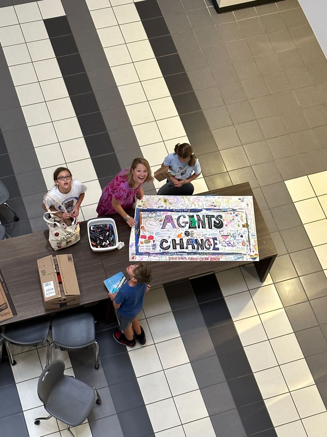 Agents of Change signage in a school hallway